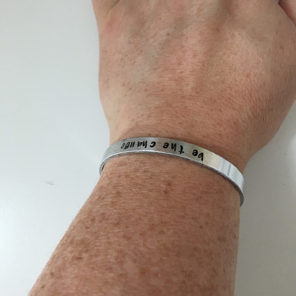 Hand stamped braclet "be the change"